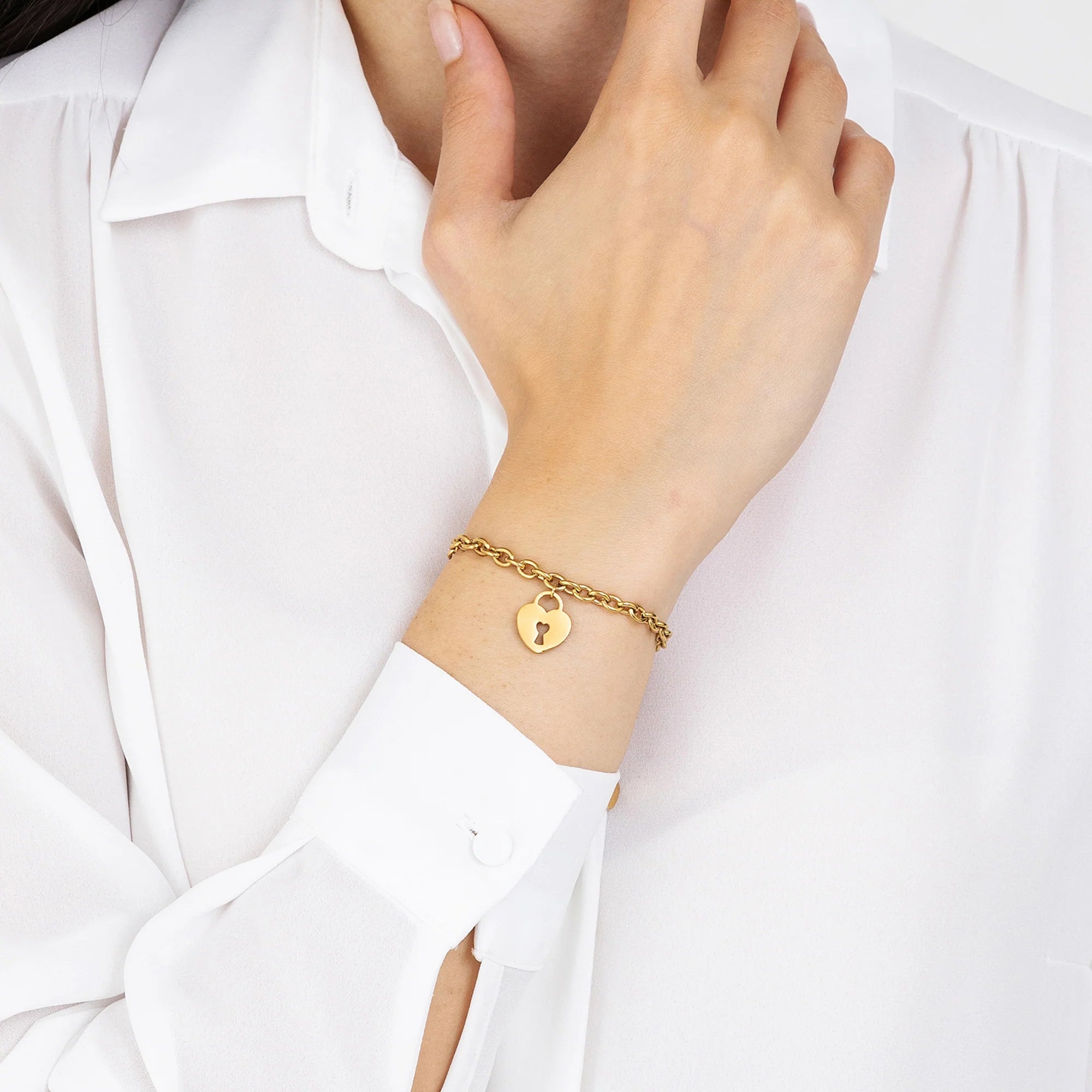 Bracciale in acciaio dorato con cuore e lucchetto