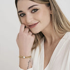 Bracciale in acciaio dorato con elemento e cristalli bianchi